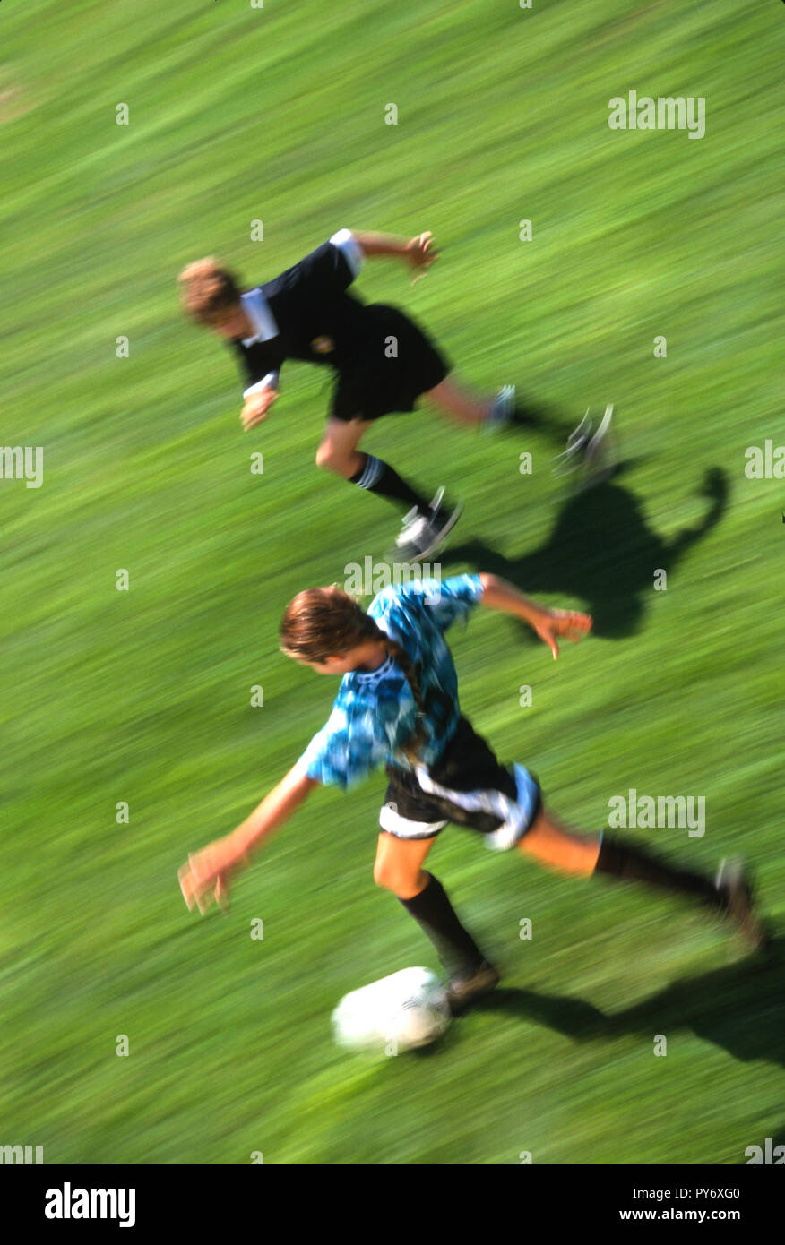 Youth soccer game with girl player and boy referee, USA Stock Photo