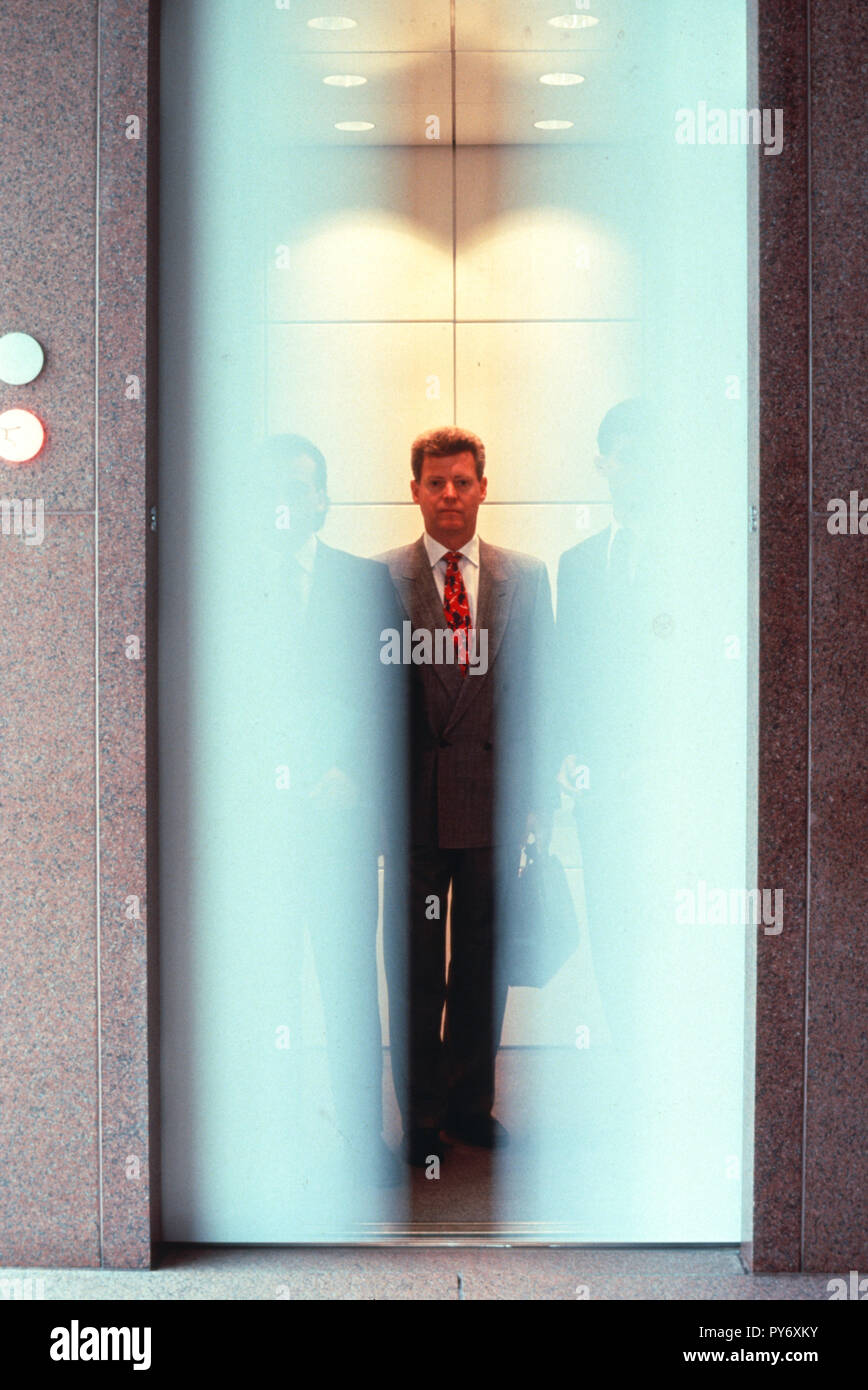 Businessmen in elevator with door movement, USA  1990s Stock Photo