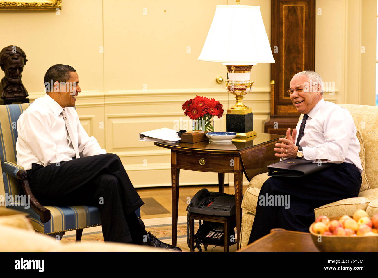 President Barack Obama meets with former Secretary of State, General Colin Powell, in the Oval Office, May 15, 2009. (Official White House Photo by Pete Souza)  This official White House photograph is being made available for publication by news organizations and/or for personal use printing by the subject(s) of the photograph. The photograph may not be manipulated in any way or used in materials, advertisements, products, or promotions that in any way suggest approval or endorsement of the President, the First Family, or the White House. Stock Photo