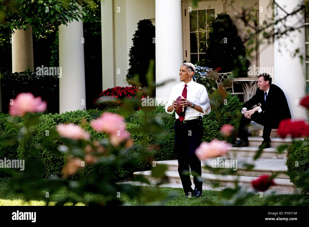 President Barack Obama Throws A Football To A Staff Member In The Rose Garden While White