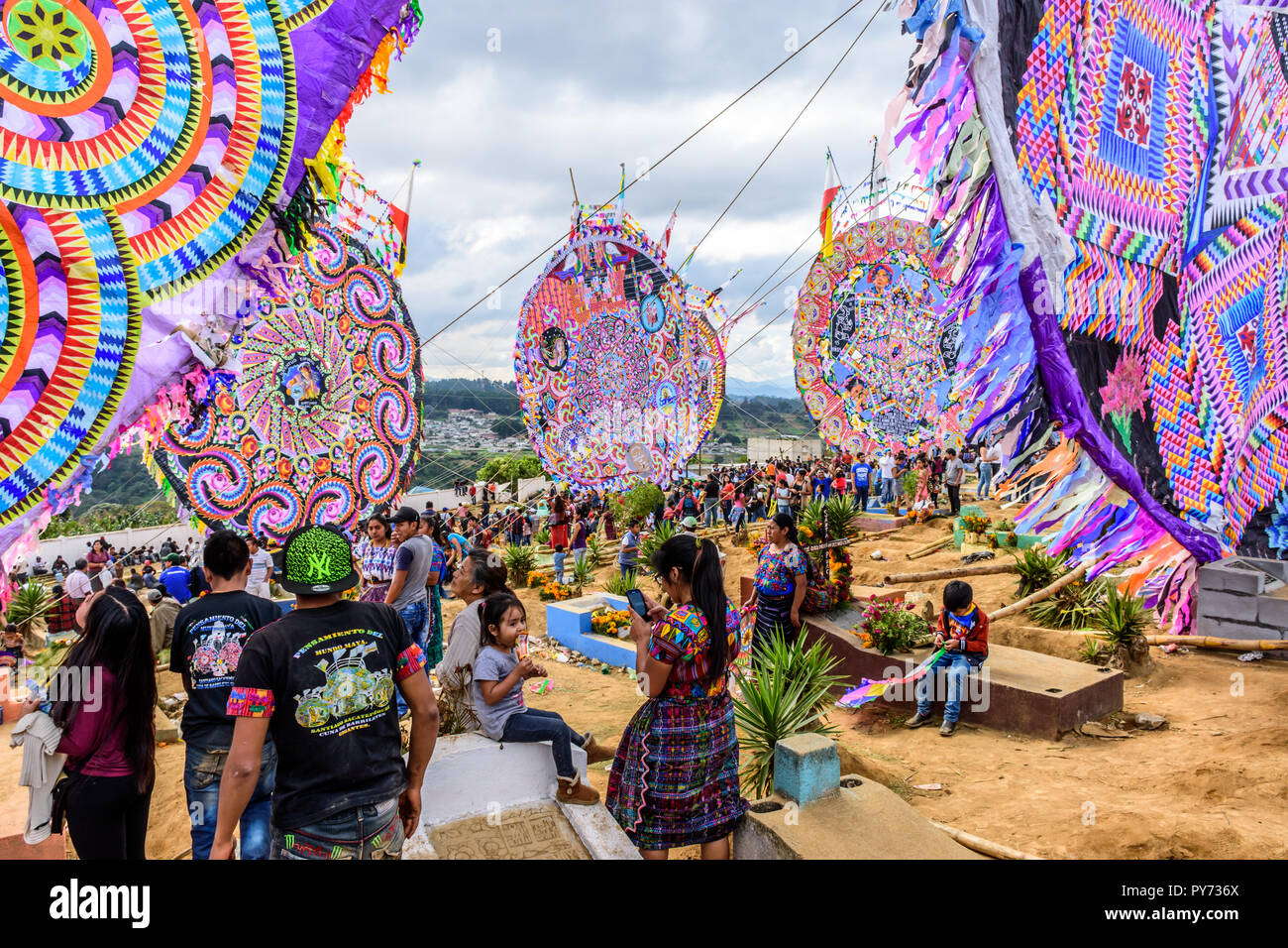 Santiago Sacatepequez, Guatemala - November 1, 2017: Giant kites amongst graves at Giant kite festival in cemetery on All Saints Day. Stock Photo