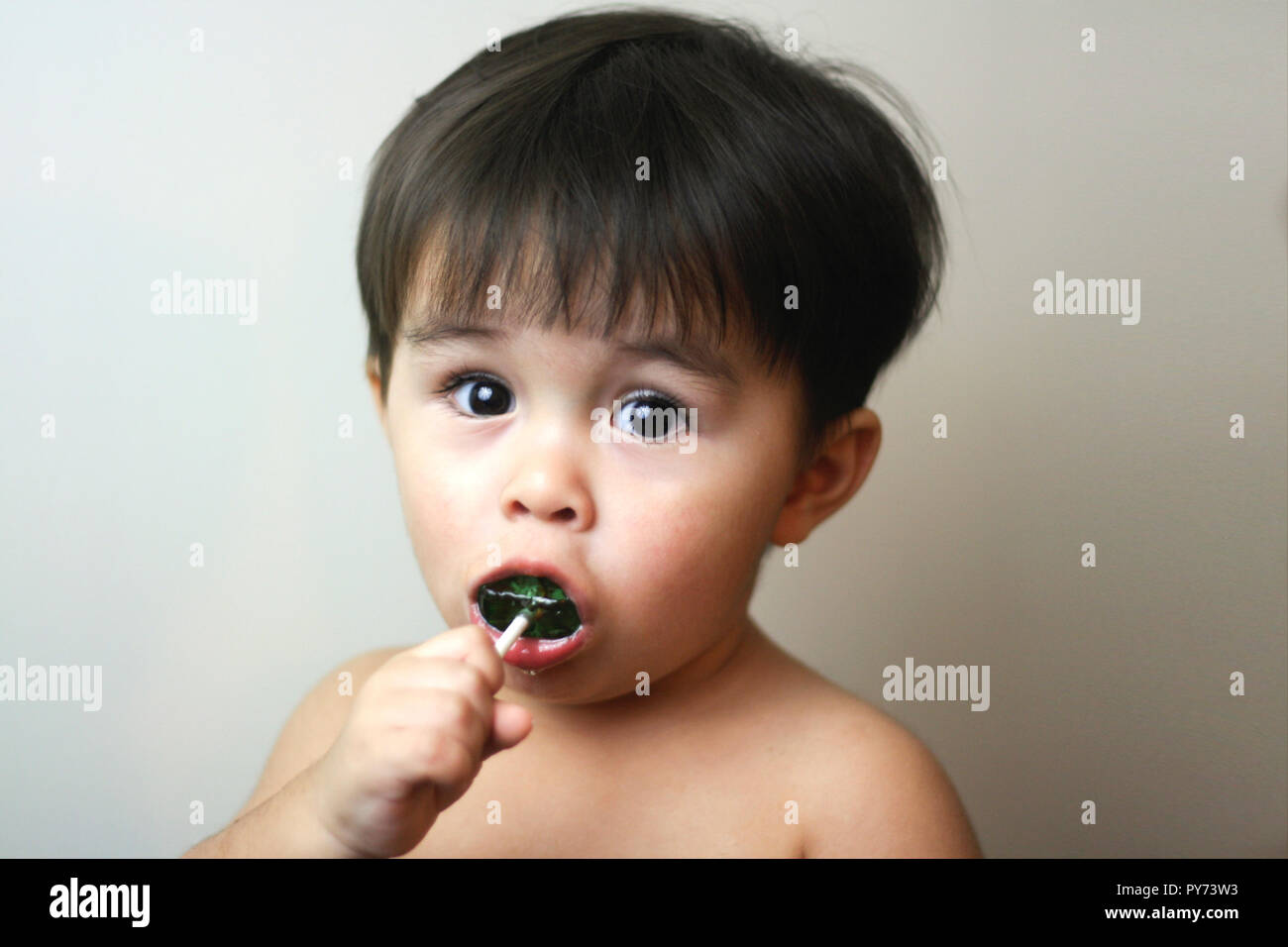 Cute toddler with creepy green scorpion candy Stock Photo
