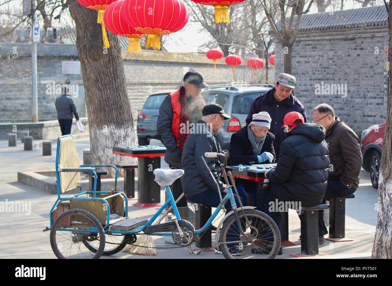 Beijing city.  Old people playing Mahjong. Between the Drum tower and the Bell tower. Stock Photo