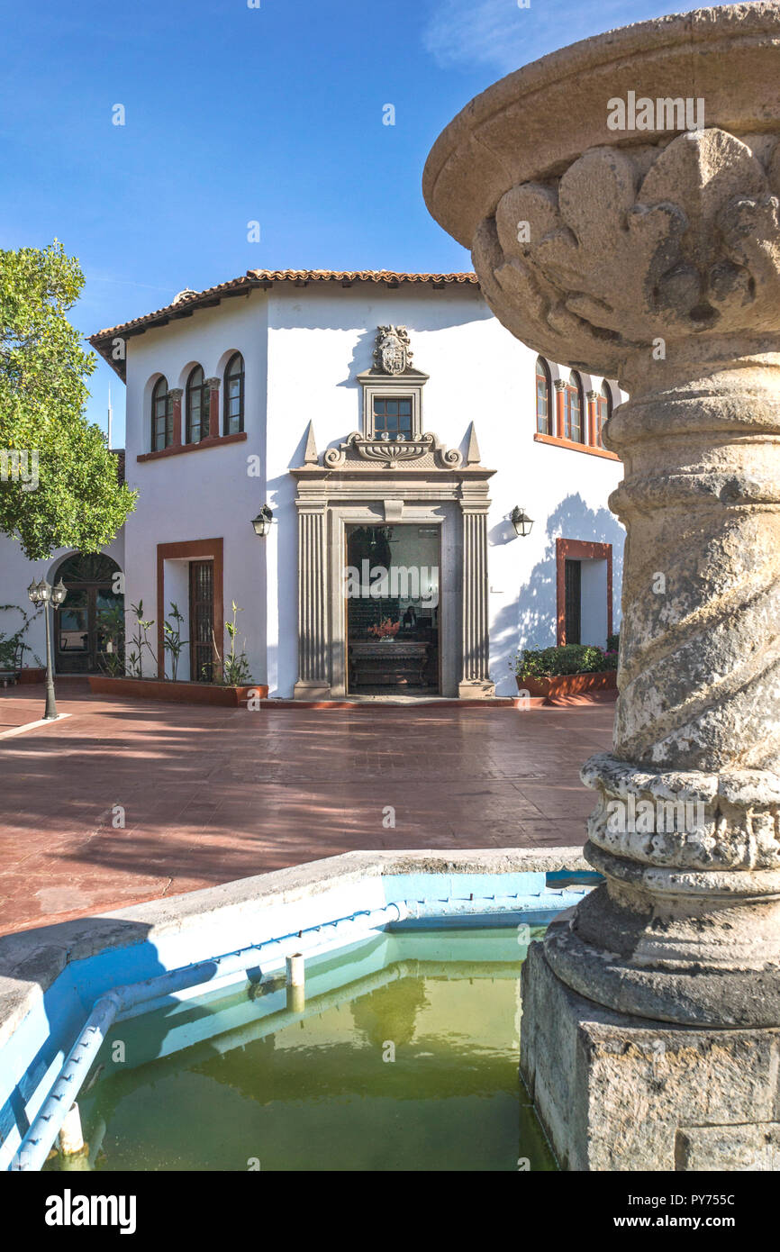 extensive tiled patio restored Spanish Colonial style Hotel Playa de Cortes with fountain & native planting facing Miramar beach Stock Photo