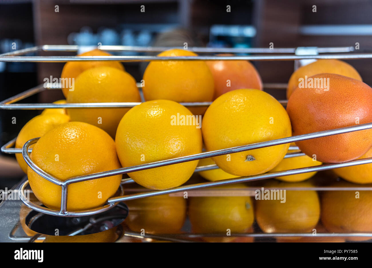Oranges in the raw on the juice machine prepared for making juice Stock