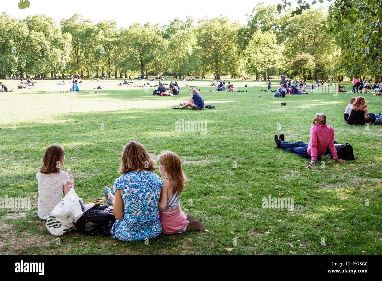 London England,UK,United Kingdom Great Britain,Green Park,Ritz Corner,Royal Parks,lawn,outdoors,green space,sitting seated on grass,adult adults woman Stock Photo