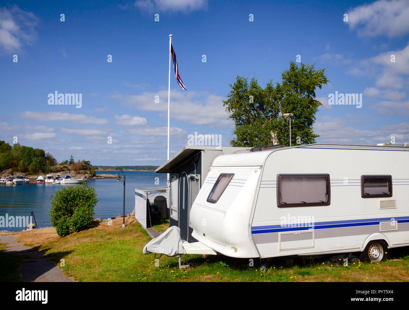 Camper trailer and cabin at seaside caravan park in Southern Norway Stock Photo