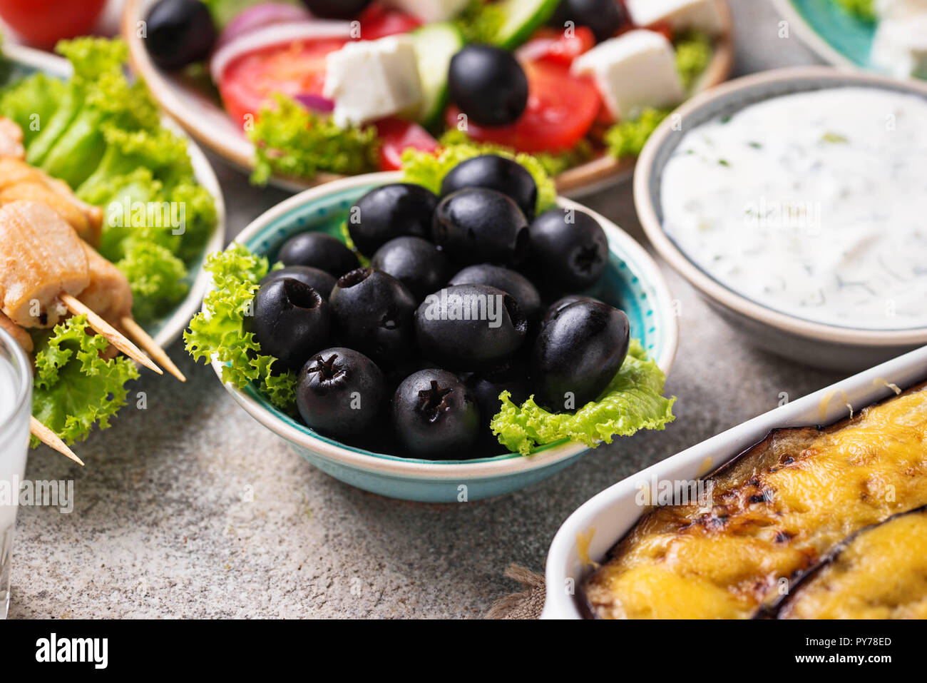 Black olives  and traditional greek dishes Stock Photo