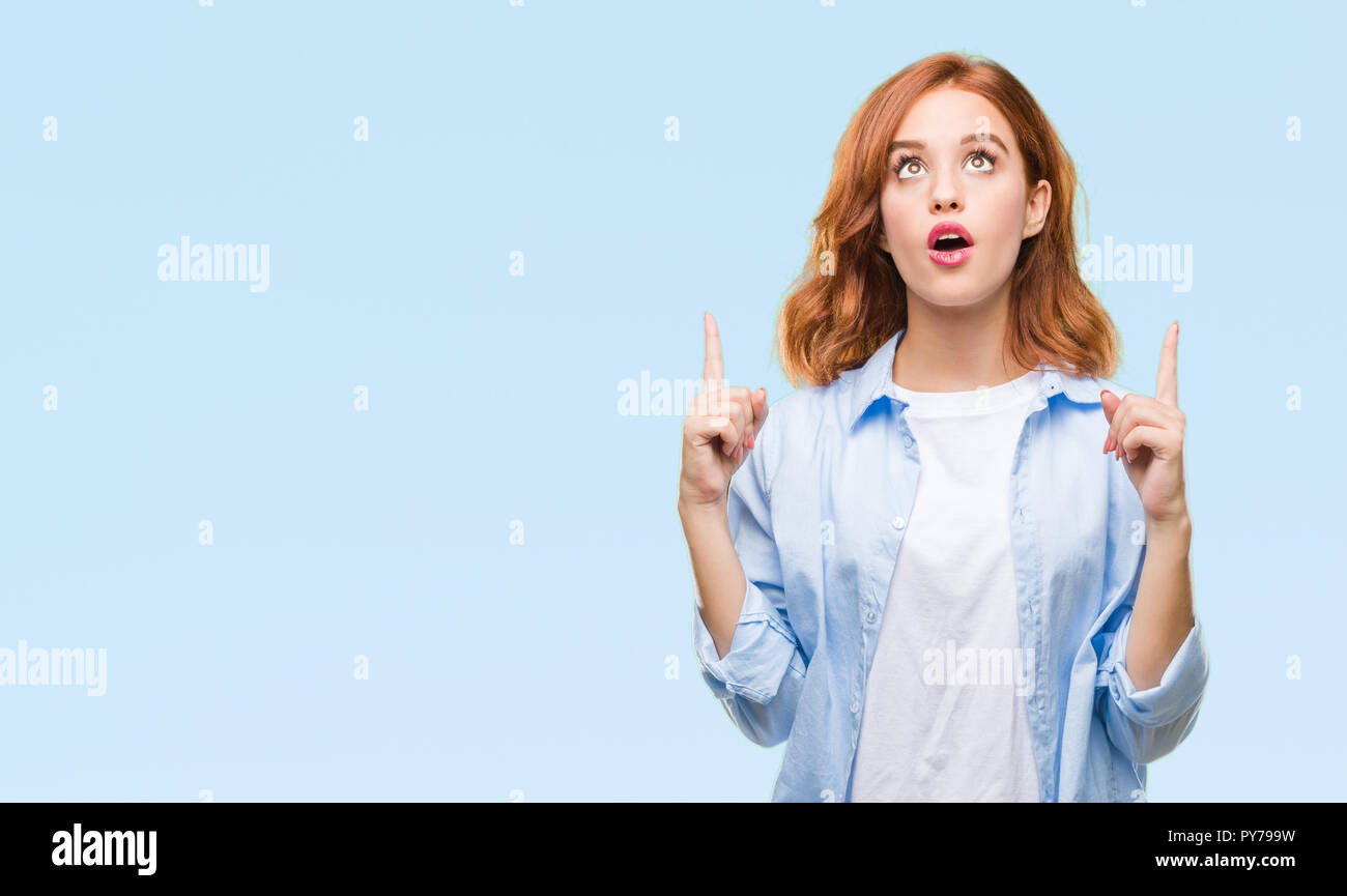 Young beautiful business woman over isolated background amazed and ...