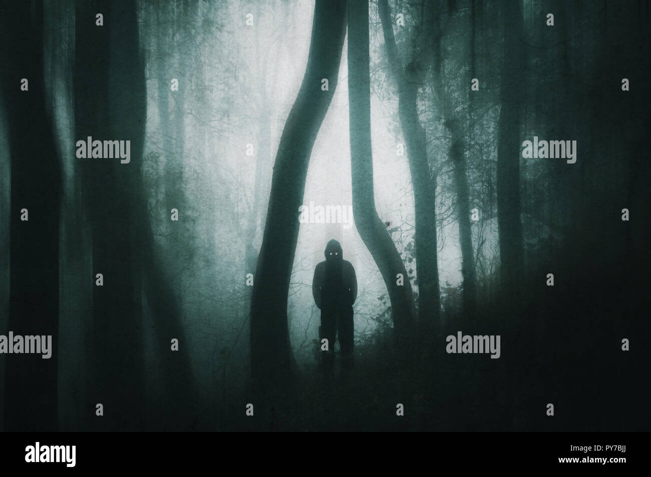 A picture of a spooky silhouetted, hooded figure with glowing eyes in a ...