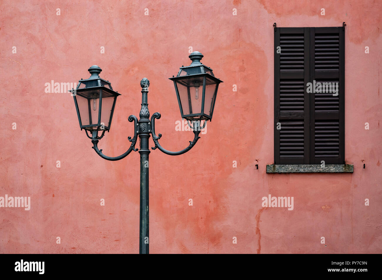 Old streetlight and shuttered window at Lecco, Italy Stock Photo