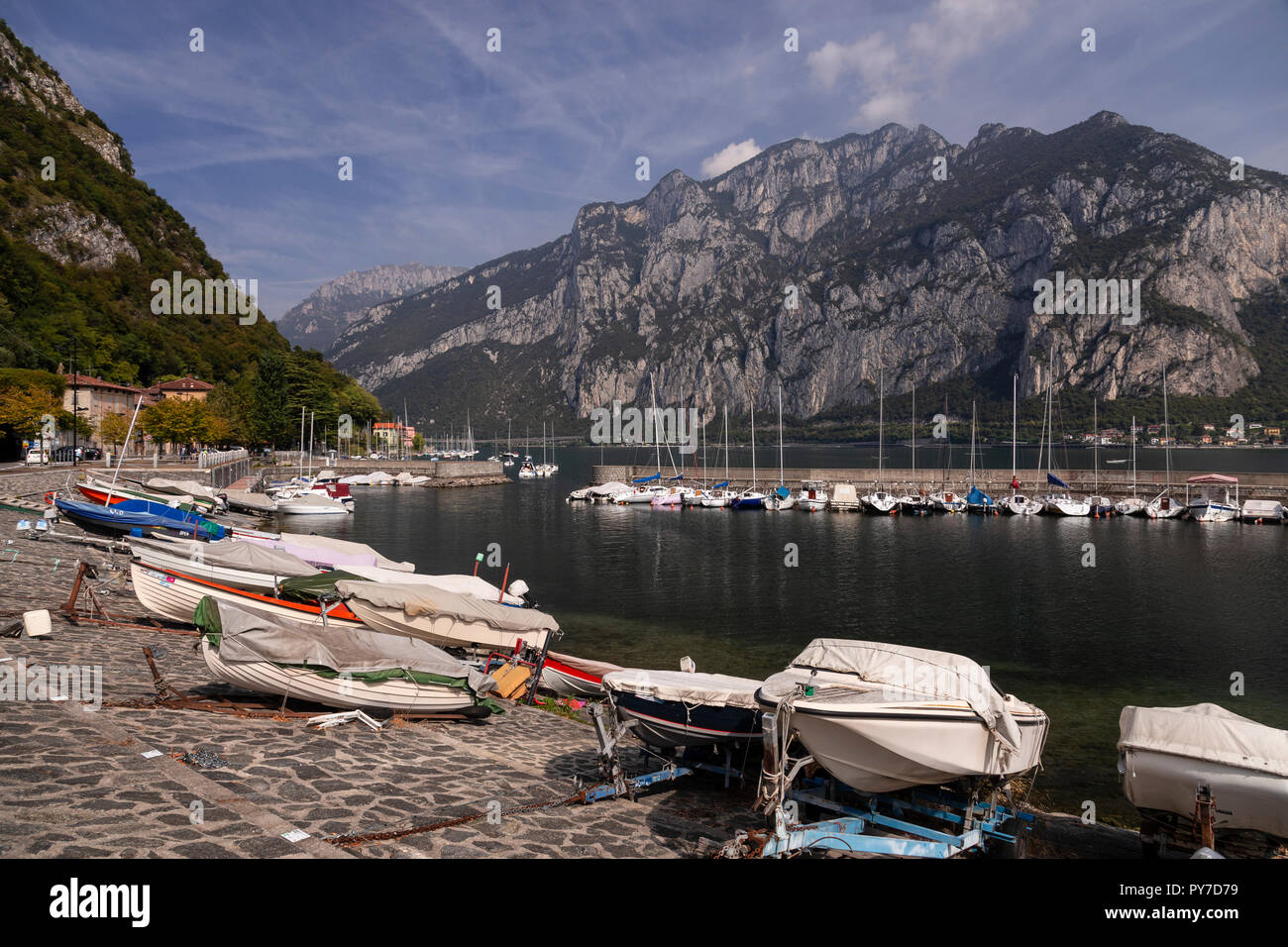 Boats at Valmedrera harbour on Lake Como, Italy, with mountains Stock Photo