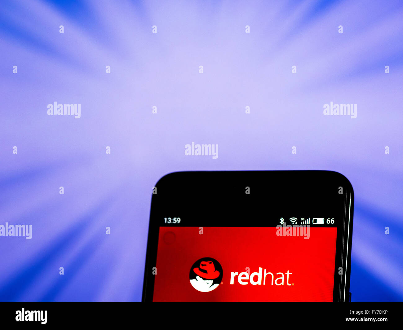 Red Hat  Software company logo seen displayed on smart phone. Red Hat, Inc. is an American multinational software company providing open-source software products to the enterprise community. Stock Photo