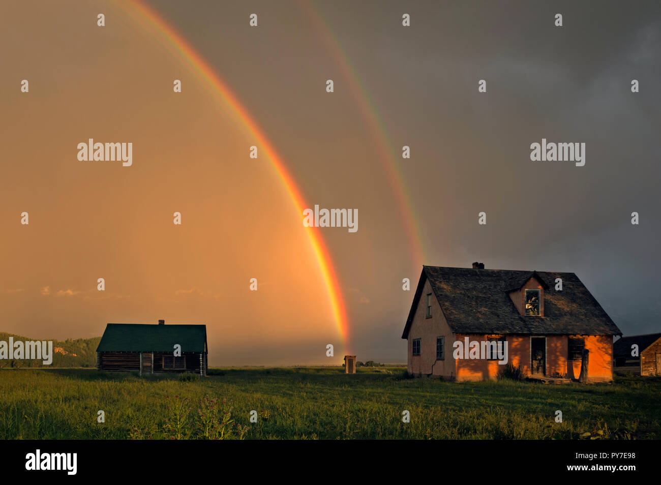 WY02506-00...WYOMING - Rainbow at sunrise at the historic Pink House homestead on Mormon Row in Grand Teton National Park. Stock Photo