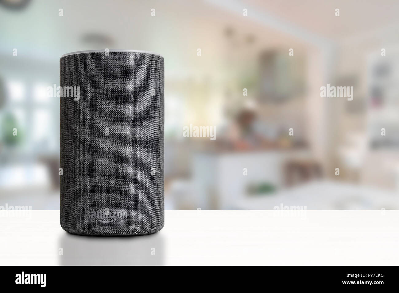 Personal assistant loudspeaker on a white wooden shelf of a smart home kitchen. Empty copy space for Editor's text. Stock Photo