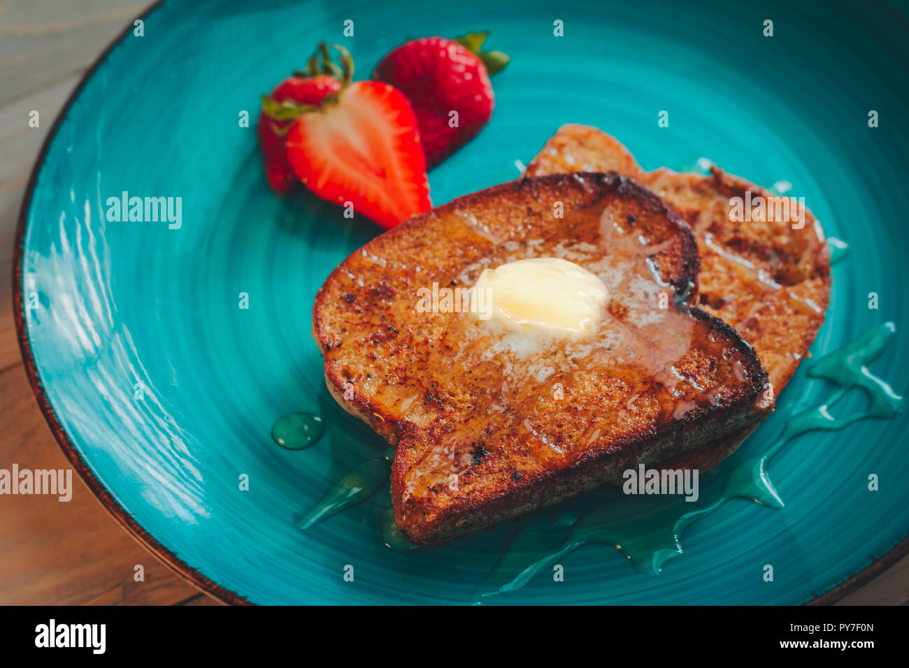 Homemade french toast with gluten free bread, strawberries and maple syrup Stock Photo