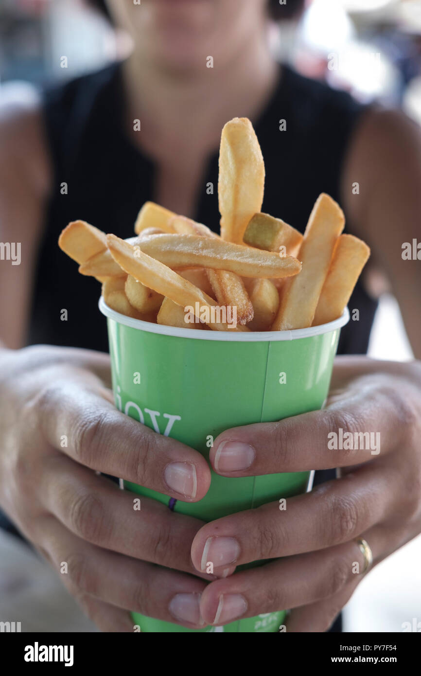 Fast food-Woman holds French fries Stock Photo