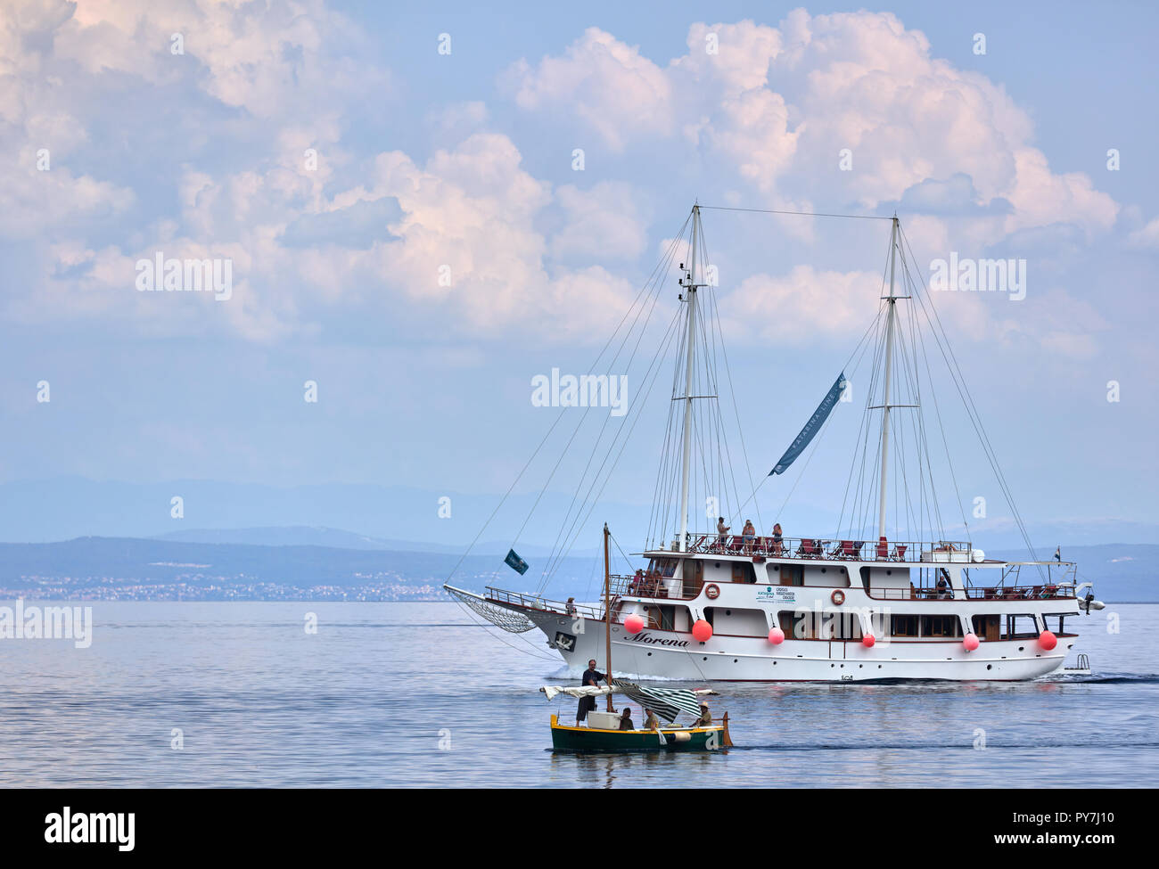 Large boat vs. small boat in Moscenicka Draga, Istria, Croatia Stock Photo
