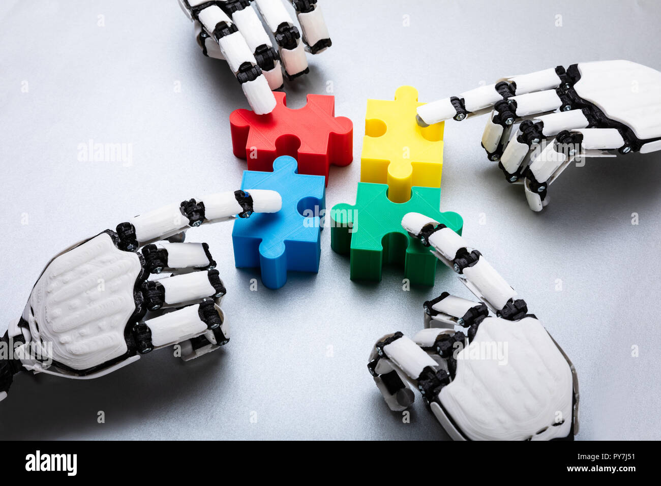 Robot Touching Colorful Jigsaw Puzzle Pieces On Gray Background Stock ...