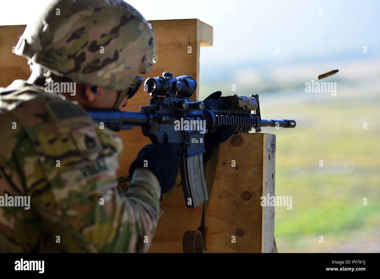 U.S. Army Paratrooper assigned to the 1st Battalion, 503rd Infantry Regiment, 173rd Airborne Brigade engages a pop-up targets with M4 carbine in kneeling position during the marksmanship training at Cao Malnisio Range, Pordenone, Italy, Oct. 24, 2018. The 173rd Airborne Brigade is the U.S. Army Contingency Response Force in Europe, capable of projecting ready forces anywhere in the U.S. European, Africa or Central Commands' areas of responsibility. (U.S. Army Photos by Paolo Bovo) Stock Photo