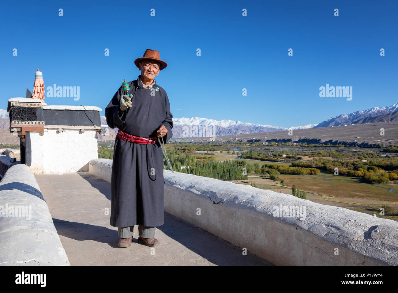 Elderly man with a prayer wheel, Spituk Gompa, Leh district, Ladakh, India Stock Photo