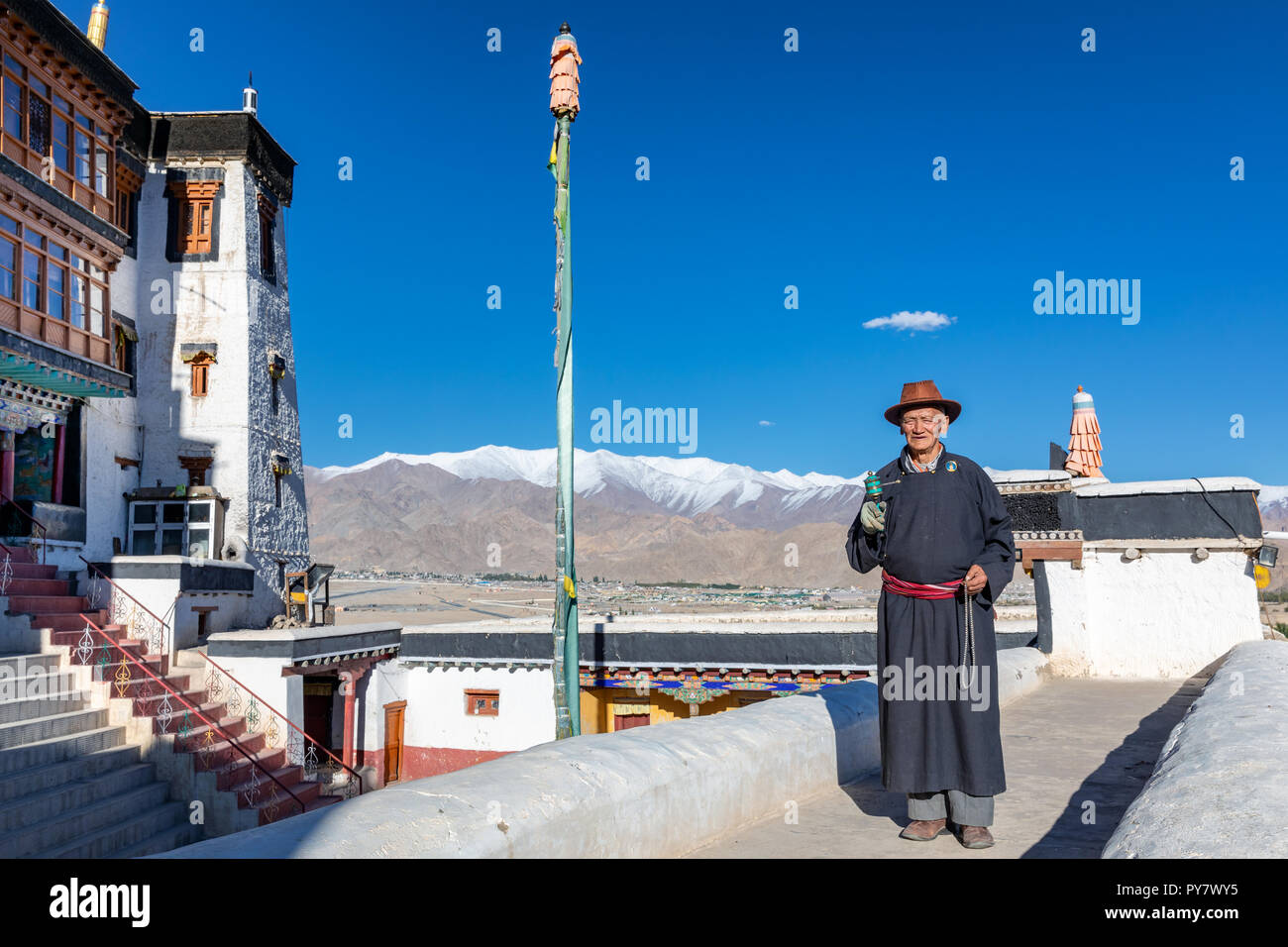 Elderly man with a prayer wheel at Spituk Gompa, Leh district, Ladakh, India Stock Photo
