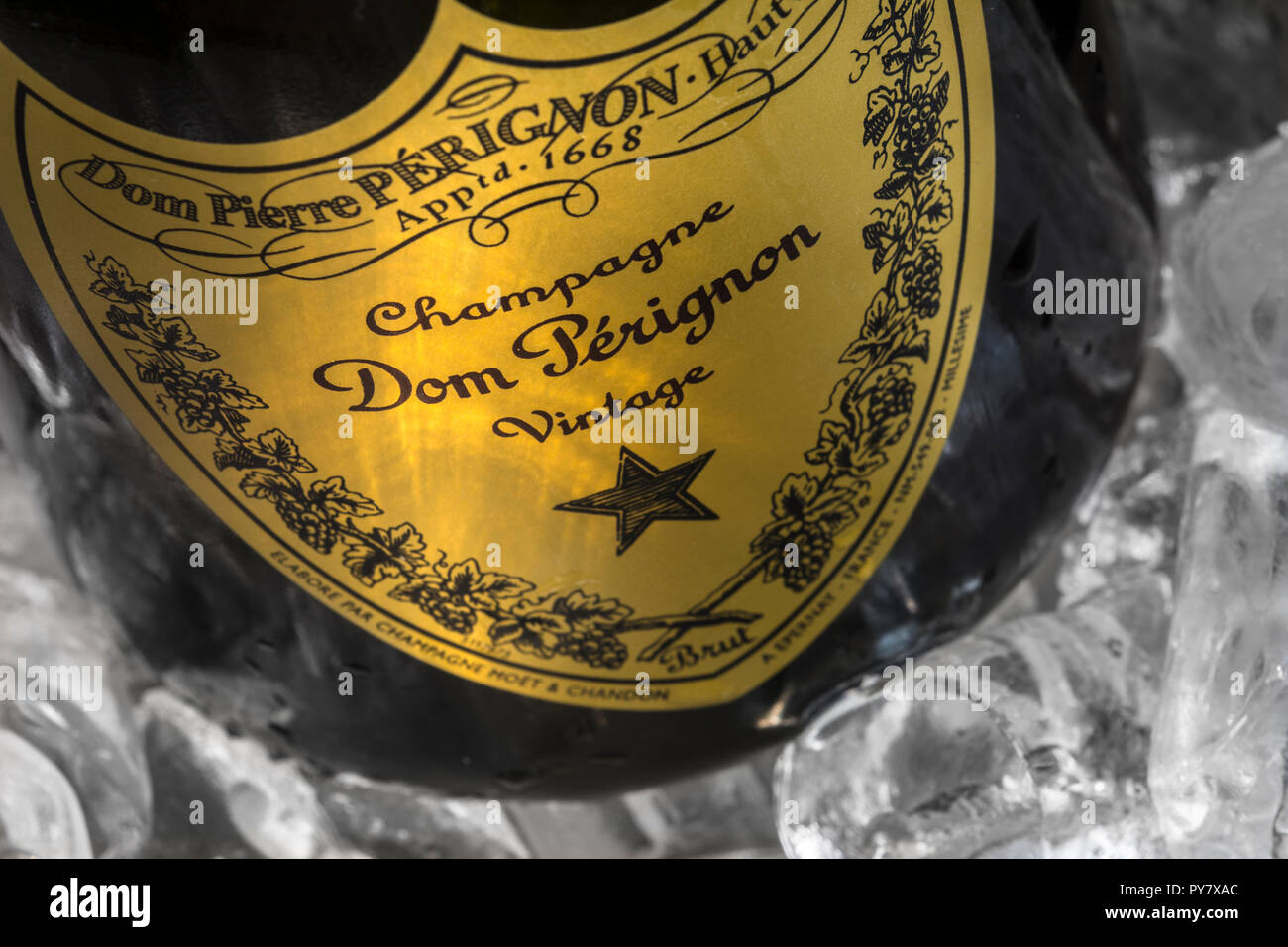 Dom Perignon label close up in champagne ice bucket with ice reflecting shafts of light on vintage Perignon champagne label in fine dining situation Stock Photo