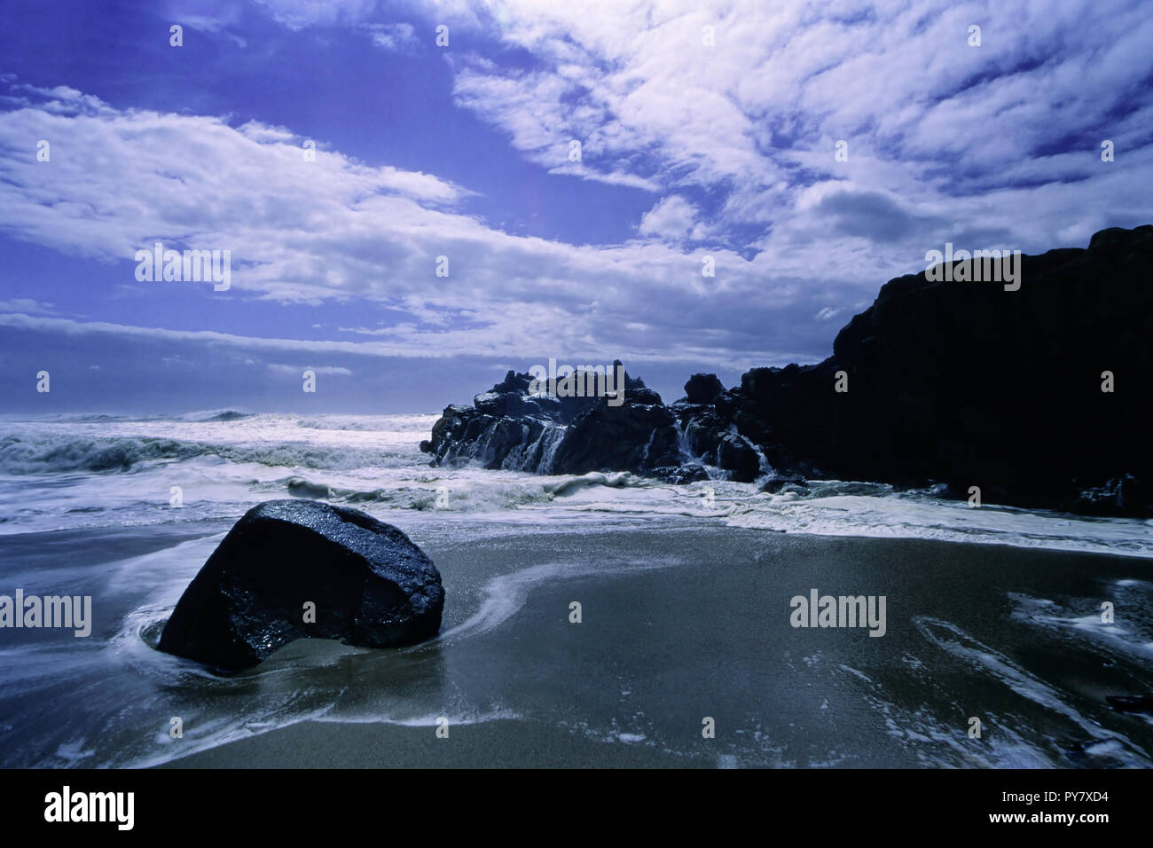 Sea cliff against deep blue sky with white clouds. Soft backlit. ANALOG ...