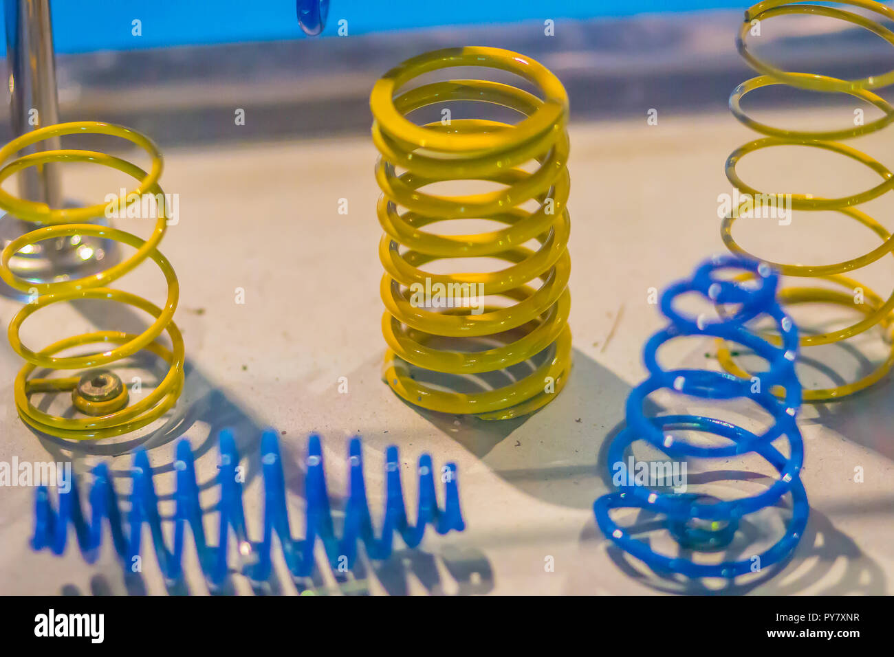 Sample product of blue and yellow metal helical coil springs Stock