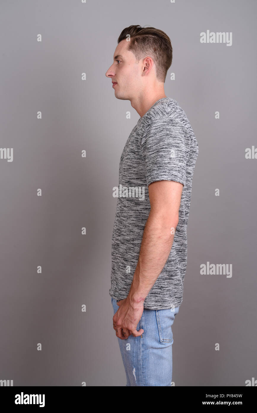 Profile view of young handsome man wearing gray shirt Stock Photo