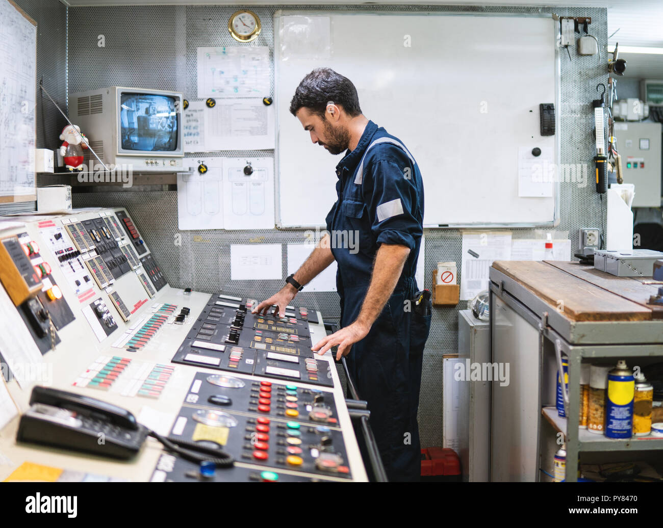 Marine engineer officer working in engine room Stock Photo