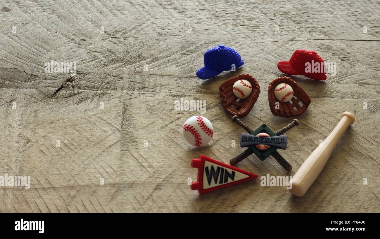 baseball hats and glove with a ball and bat on a natural wood surface with writing space Stock Photo