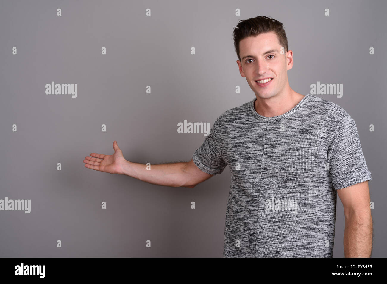 Portrait of young handsome man showing copy space Stock Photo