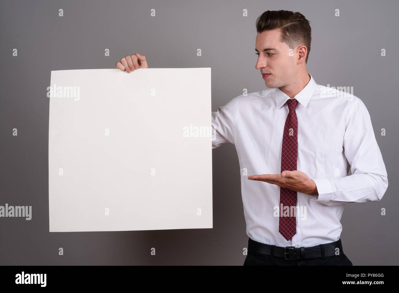 Businessman holding empty white board with copy space Stock Photo - Alamy