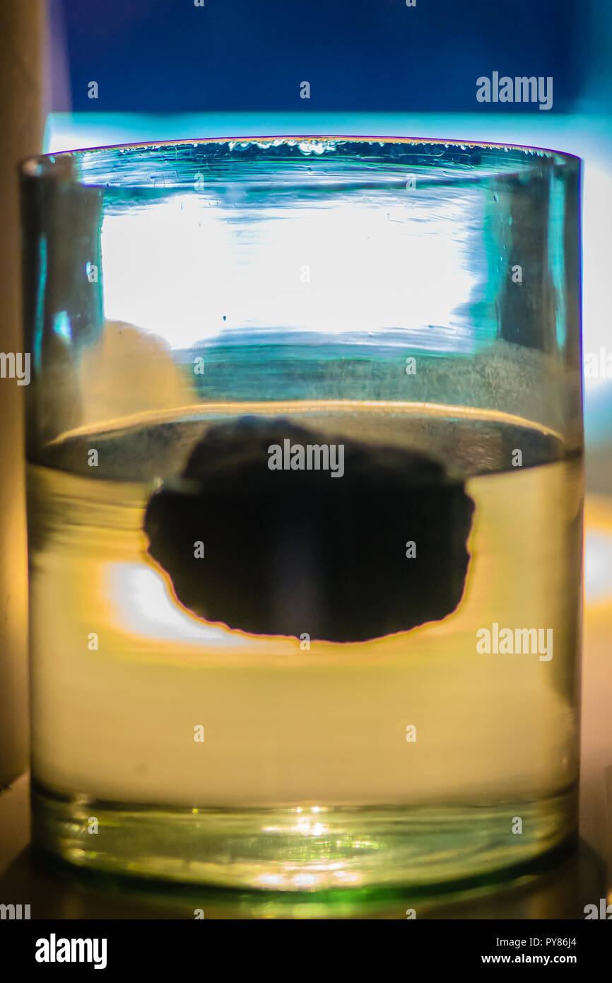 Pumice stone is floating on the water. Pumice has an average porosity