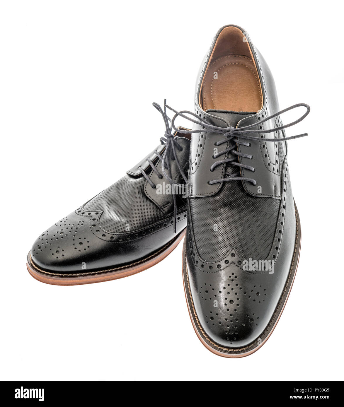 A pair of mens black wingtip dress shoes on an isolated background Stock Photo