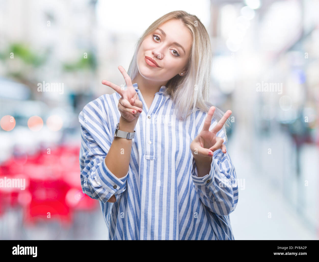 Young blonde woman over isolated background smiling looking to the ...