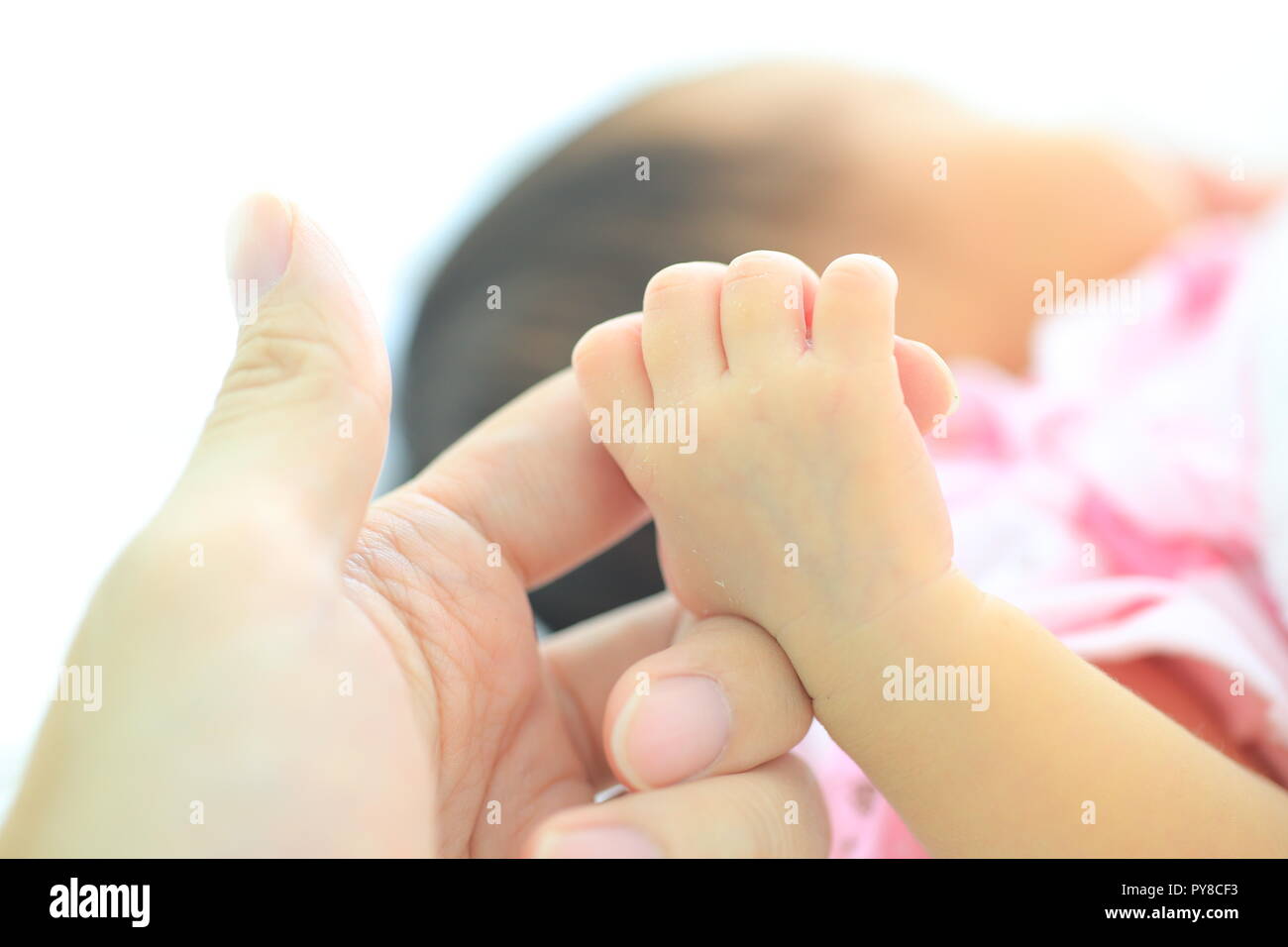 hand of new born baby holding it's mother finger. soft and secure love. Stock Photo