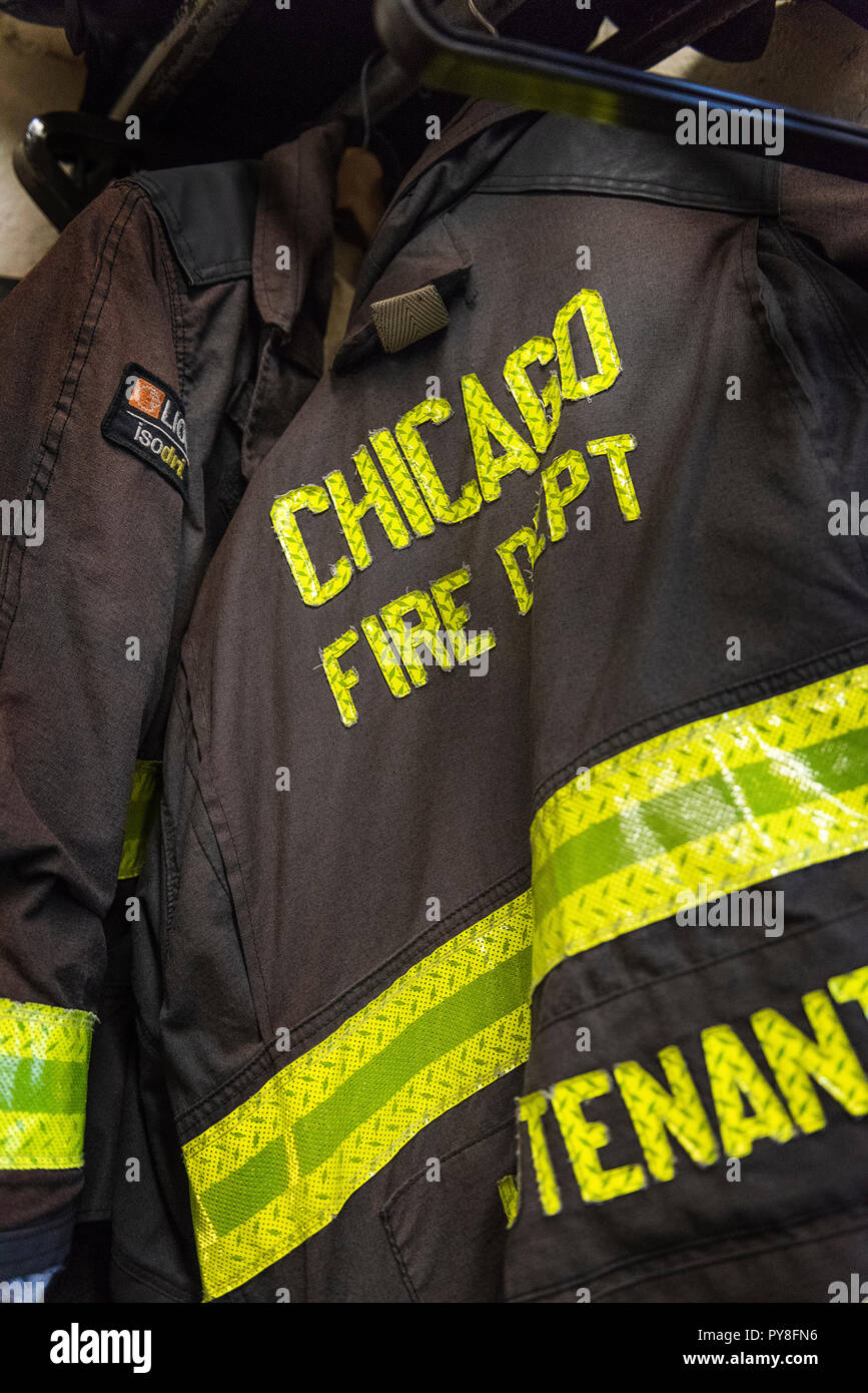 CHICAGO, ILLINOIS, USA - OCTOBER 10, 2018: The fireman's clothes by the real squad fire truck in Chicago Fire Department at the quarters of Engine Co. Stock Photo