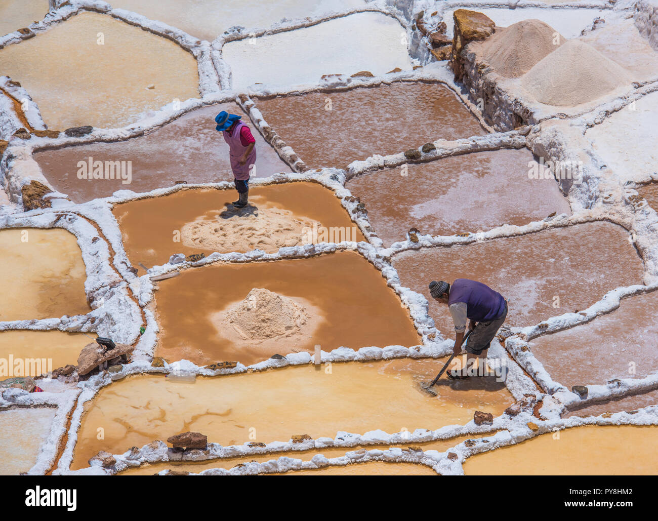 SALINAS DE MARAS, PERU OCTOBER 12, 2015 Workers extracting salt at