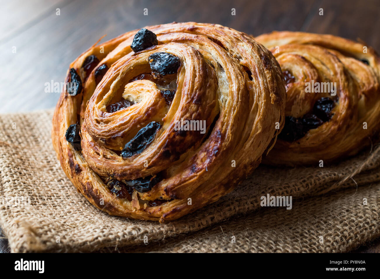 Danish Spiral Cinnamon Raisin Roll / German Pastry Schnecken on Sack. Traditional Food. Stock Photo