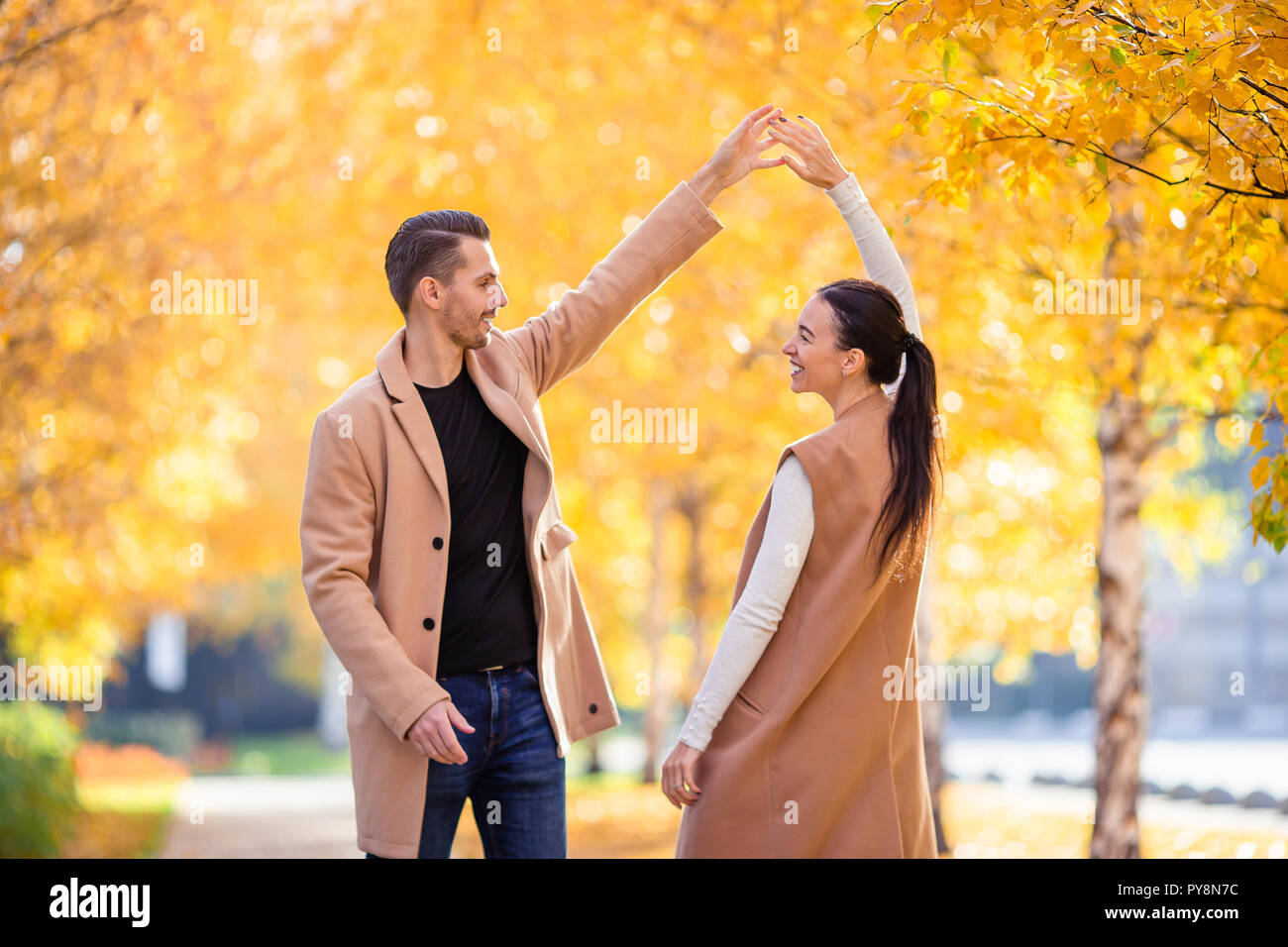 Happy family walking in autumn park on sunny fall day Stock Photo - Alamy
