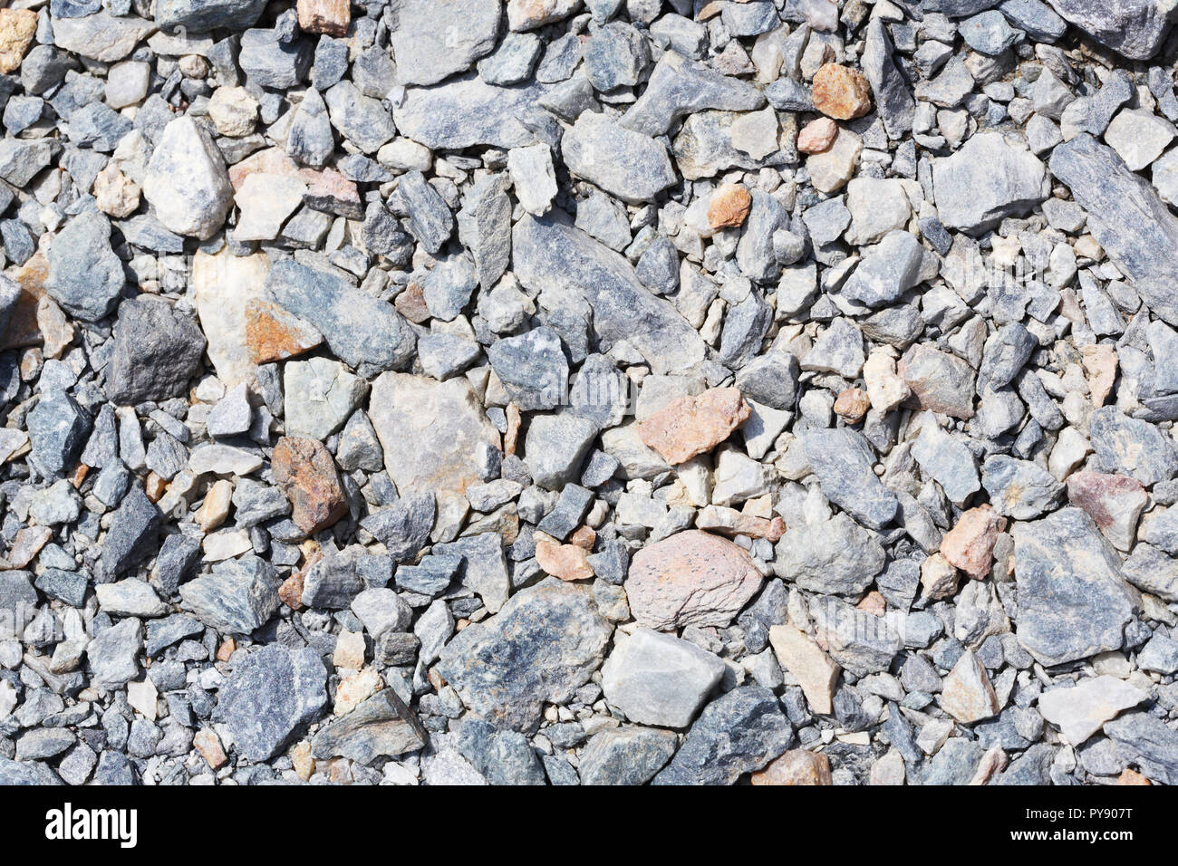 Multicolored crushed stone in bright sunlight day Stock Photo