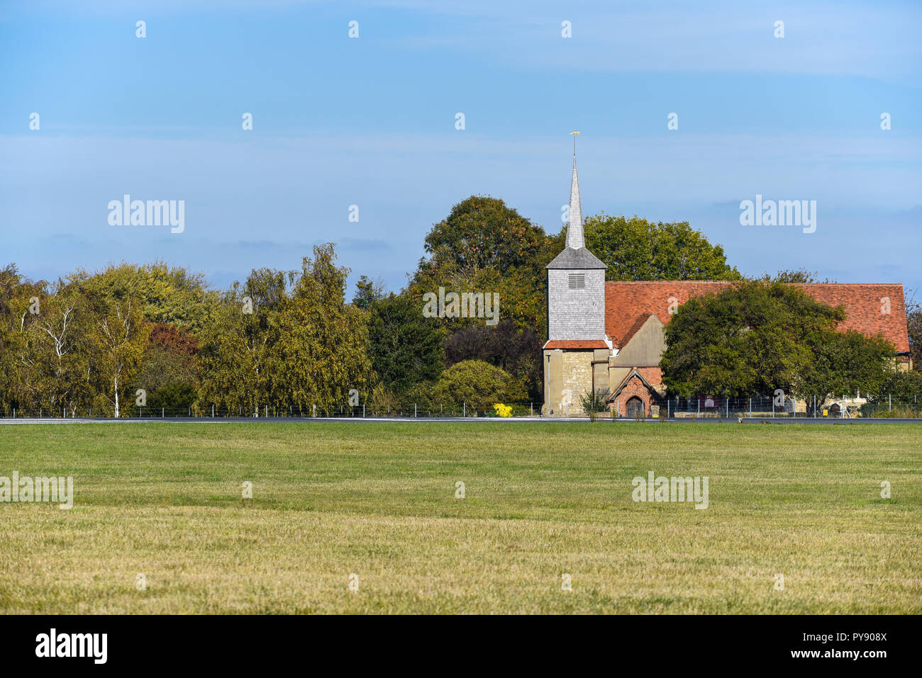 St Laurence and All Saints church on the edge of the runway at London Southend Airport, Eastwood, Essex, UK. Space for copy Stock Photo