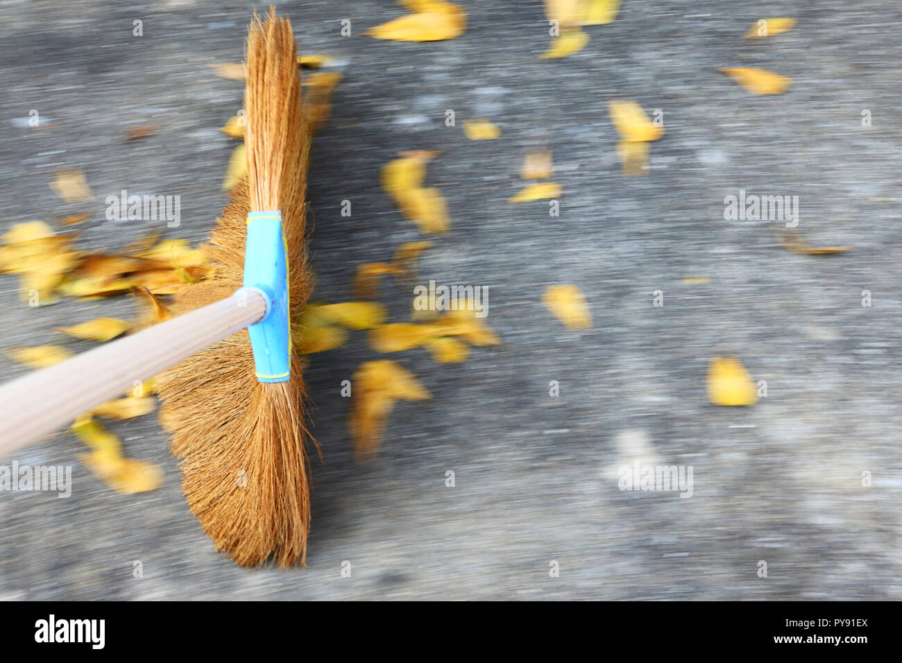 Sweeping the floor with moving motion over ground and leaves Stock