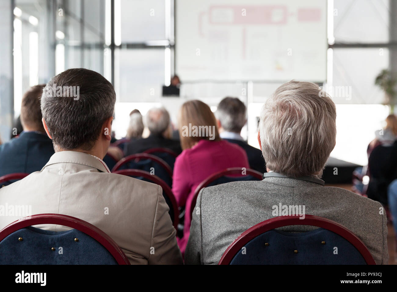 Participants at a professional or business conference listening speaker's presentation. Stock Photo