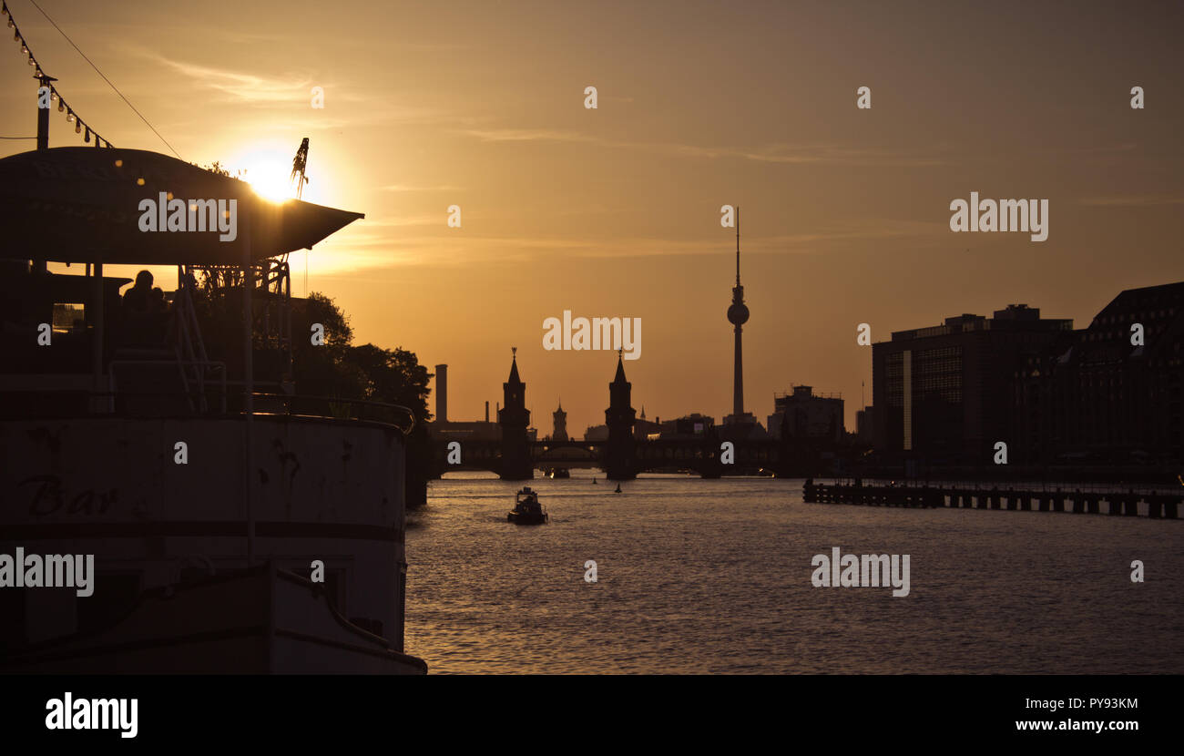 Sunset city view of TV tower and Oberbaum bridge near river Spree. Kreuzberge, Friedrichshain Stock Photo