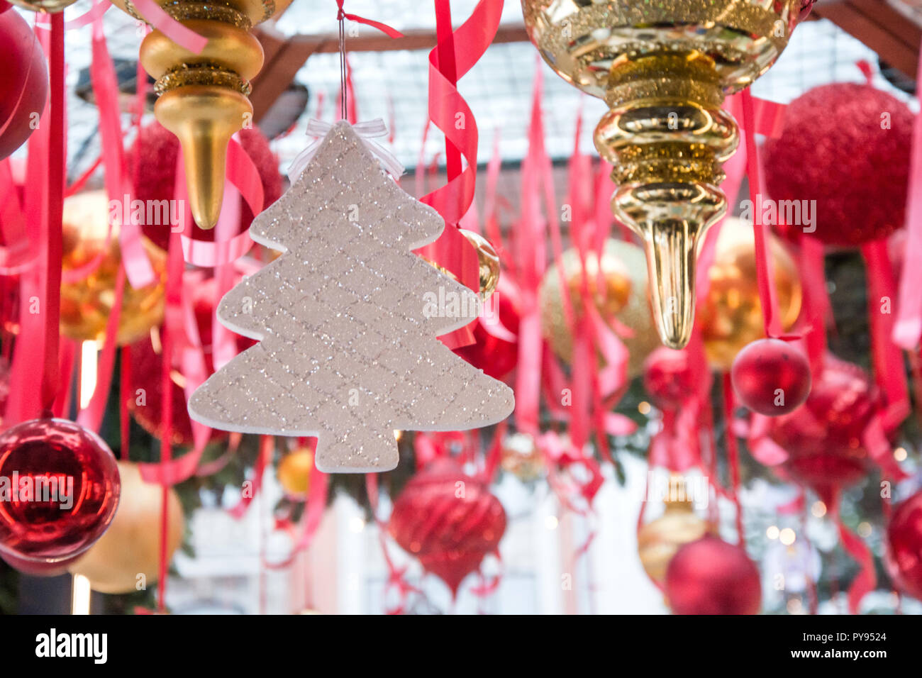 Christmas white tree hanging on red ribbons in fair kiosk for ...