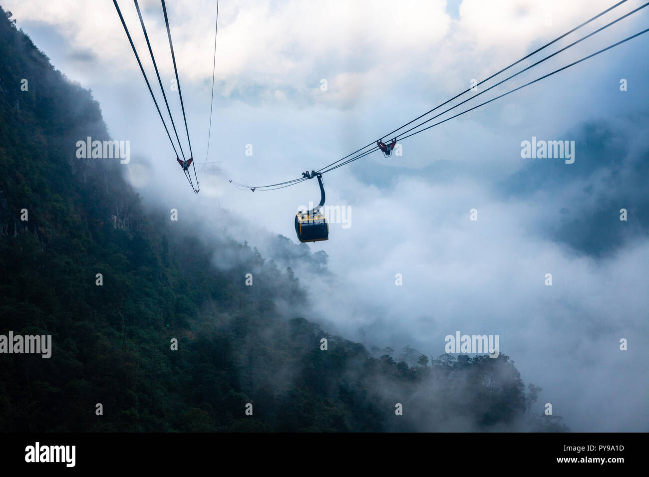 View from Fansipan Cable Car during the rain. Longest non-stop three-rope cable car in the world. Sa Pa, Vietnam. Stock Photo