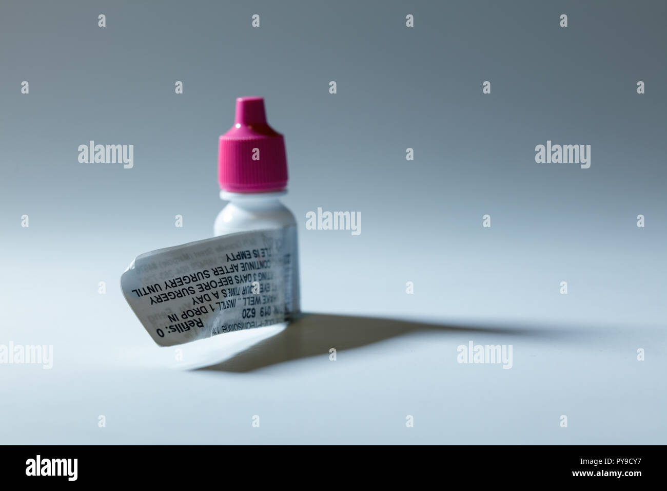 Pink cap eye drop bottle, antibiotic prescription medicine Stock Photo